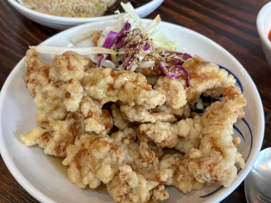 Small sweet and sour pork served with cabbage salad