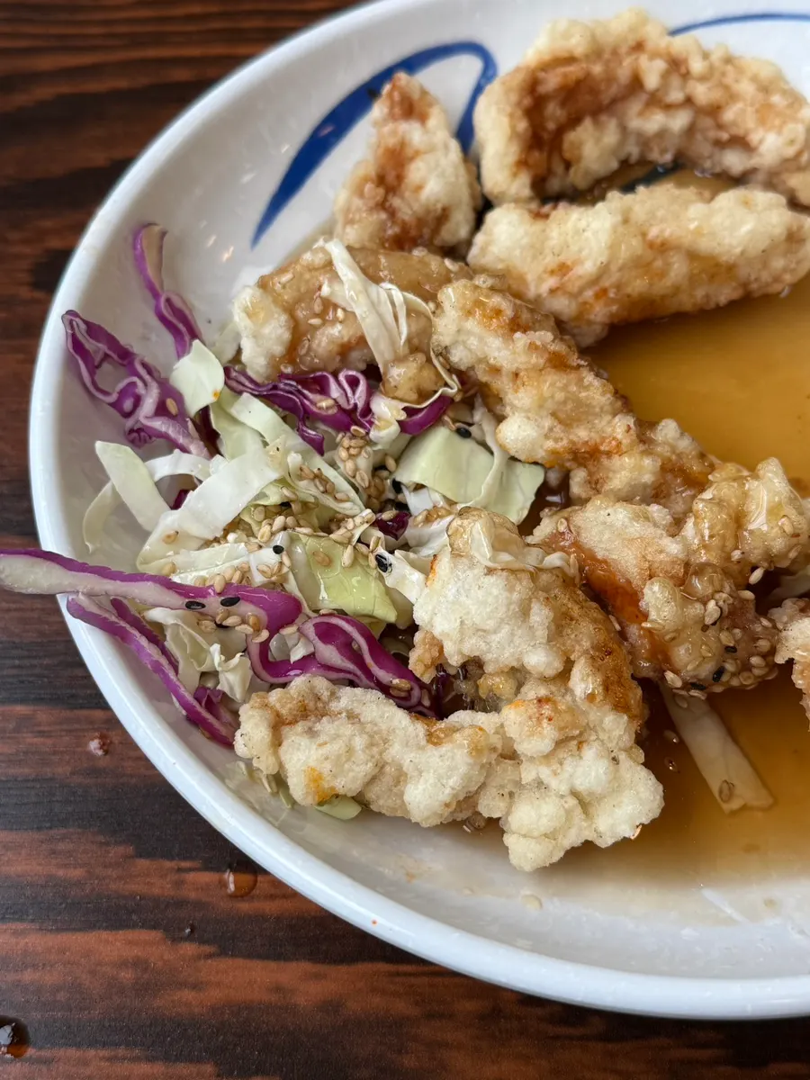Small tangsuyuk served with sauce and cabbage