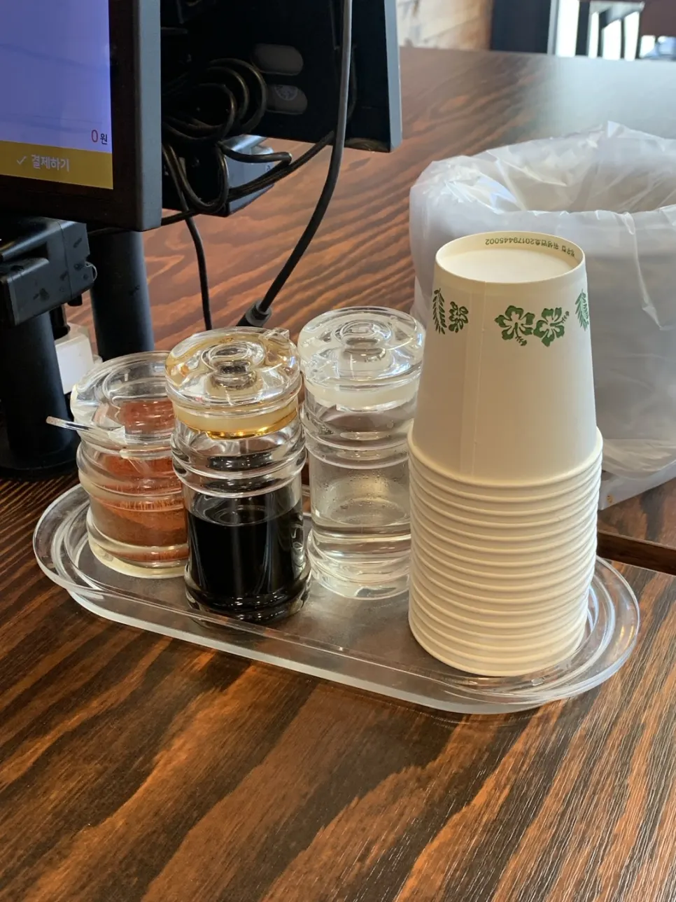 Chili powder, soy sauce, vinegar and paper cups on the table