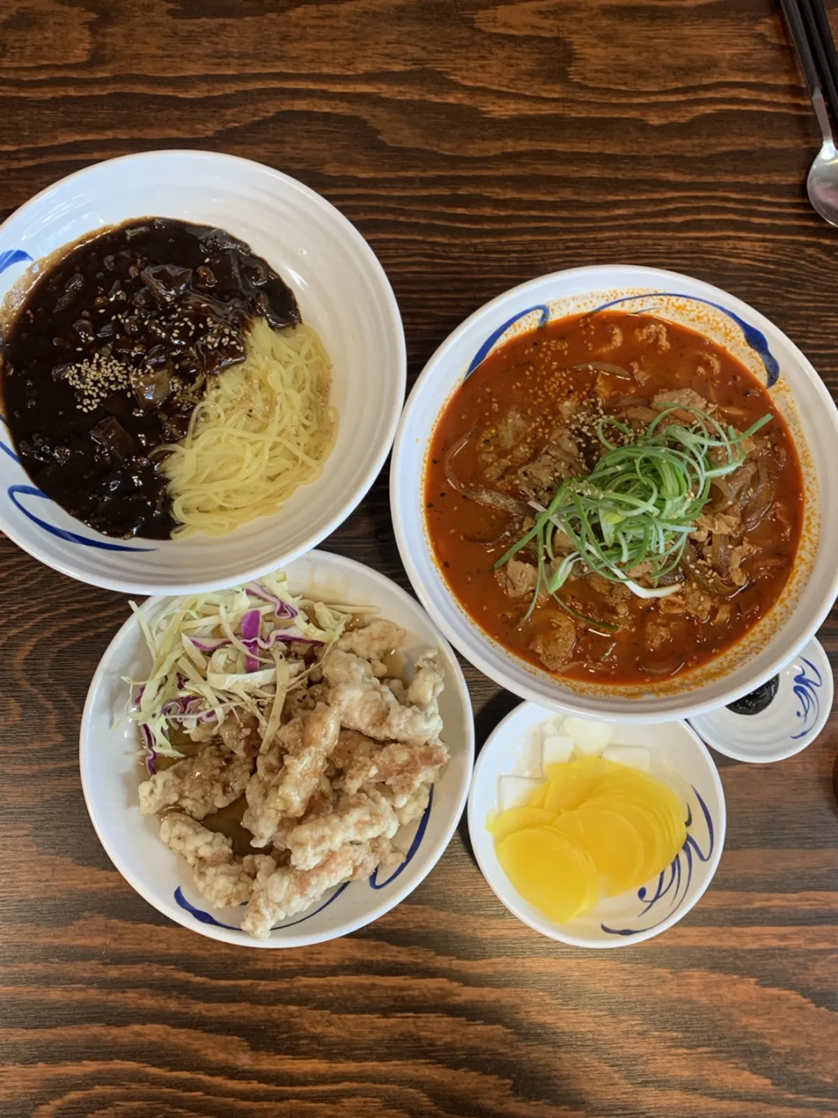 Full table spread of jjajangmyeon, jjambbong, and sweet and sour pork