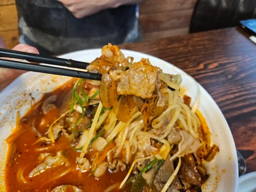 Rich broth meat jjambbong topped with scallion shreds