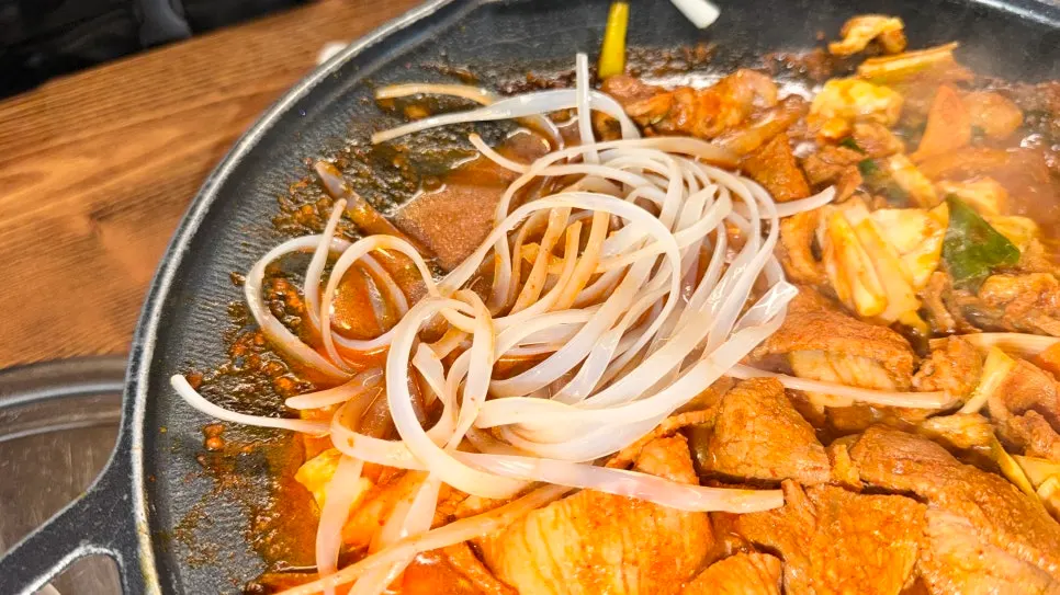 Gochujang jumulleok simmering in a brothy sauce