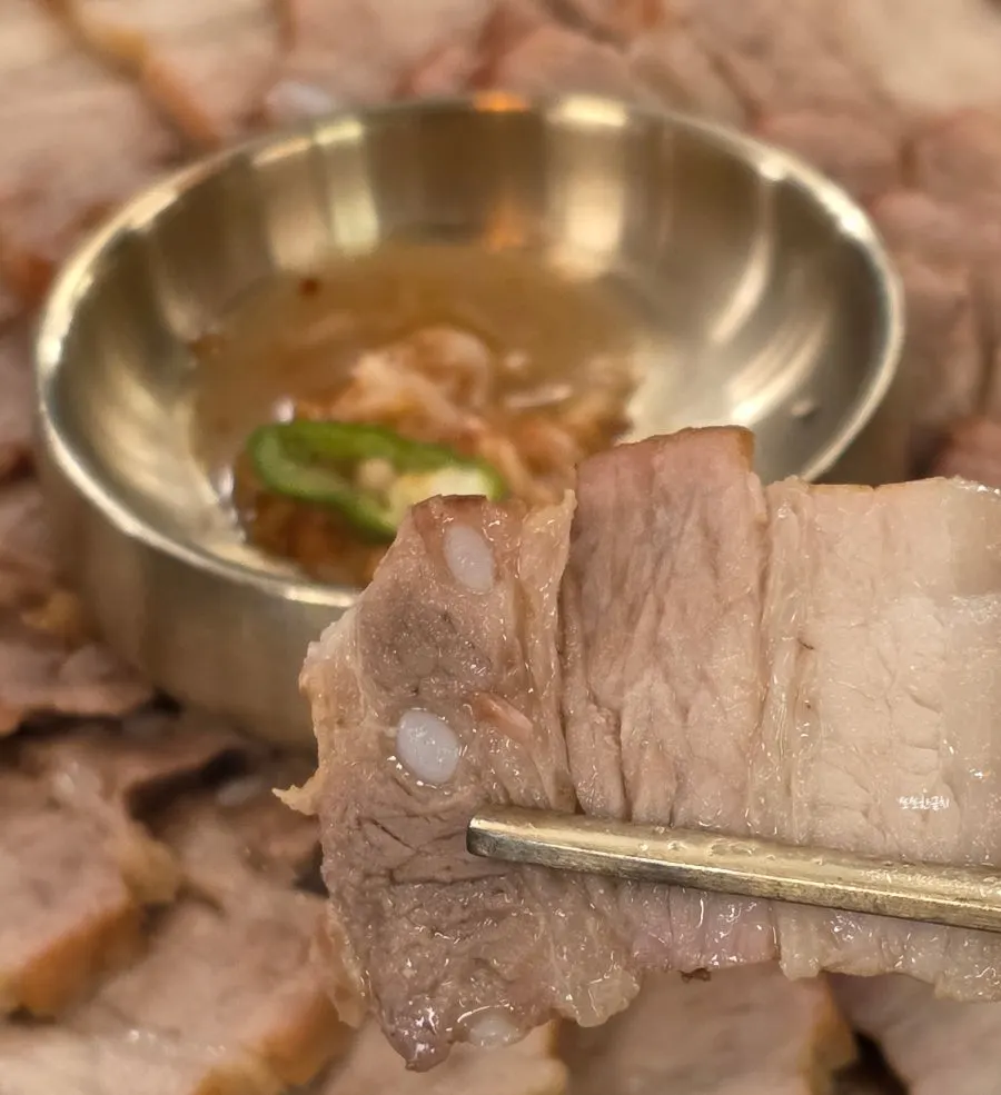수육에 새우젓과 무말랭이를 올린 모습