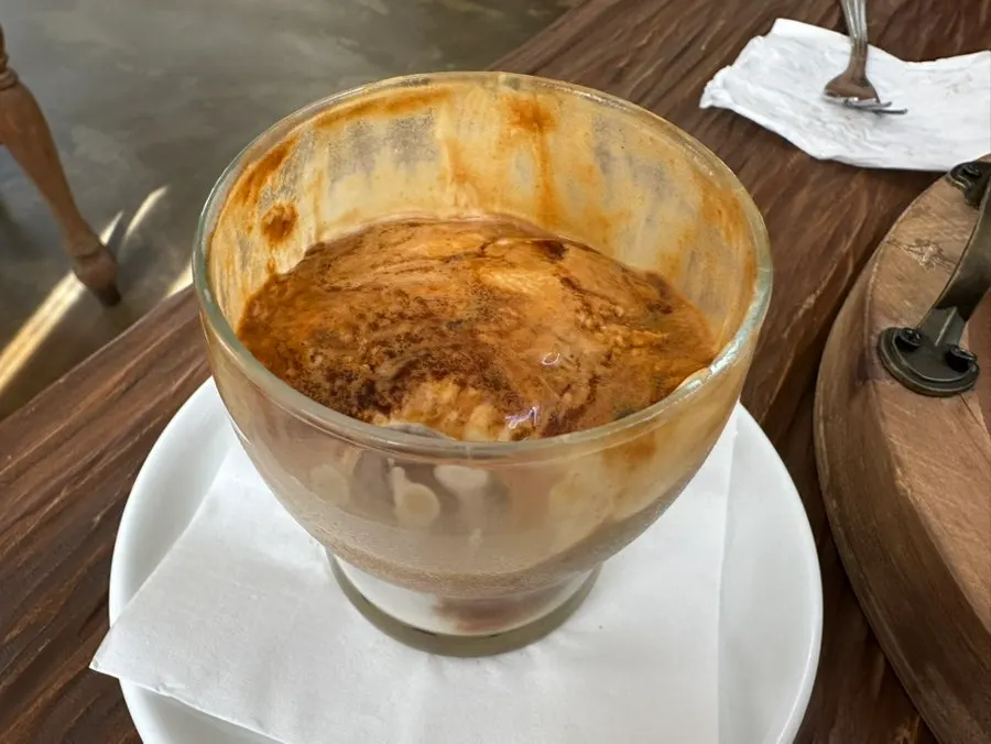 Pomun coffee cup topped with cream