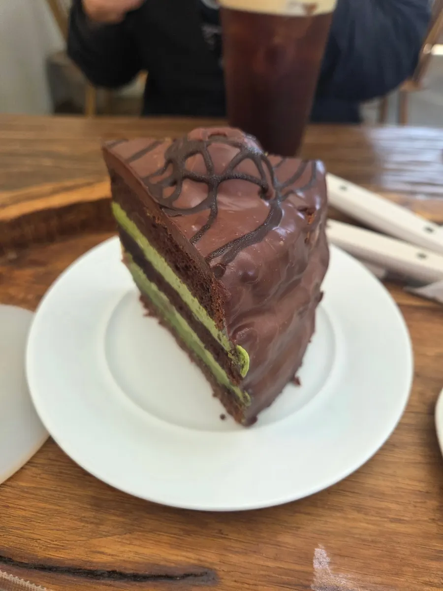 Chestnut matcha chocolate cake, coffee, and a lemon madeleine