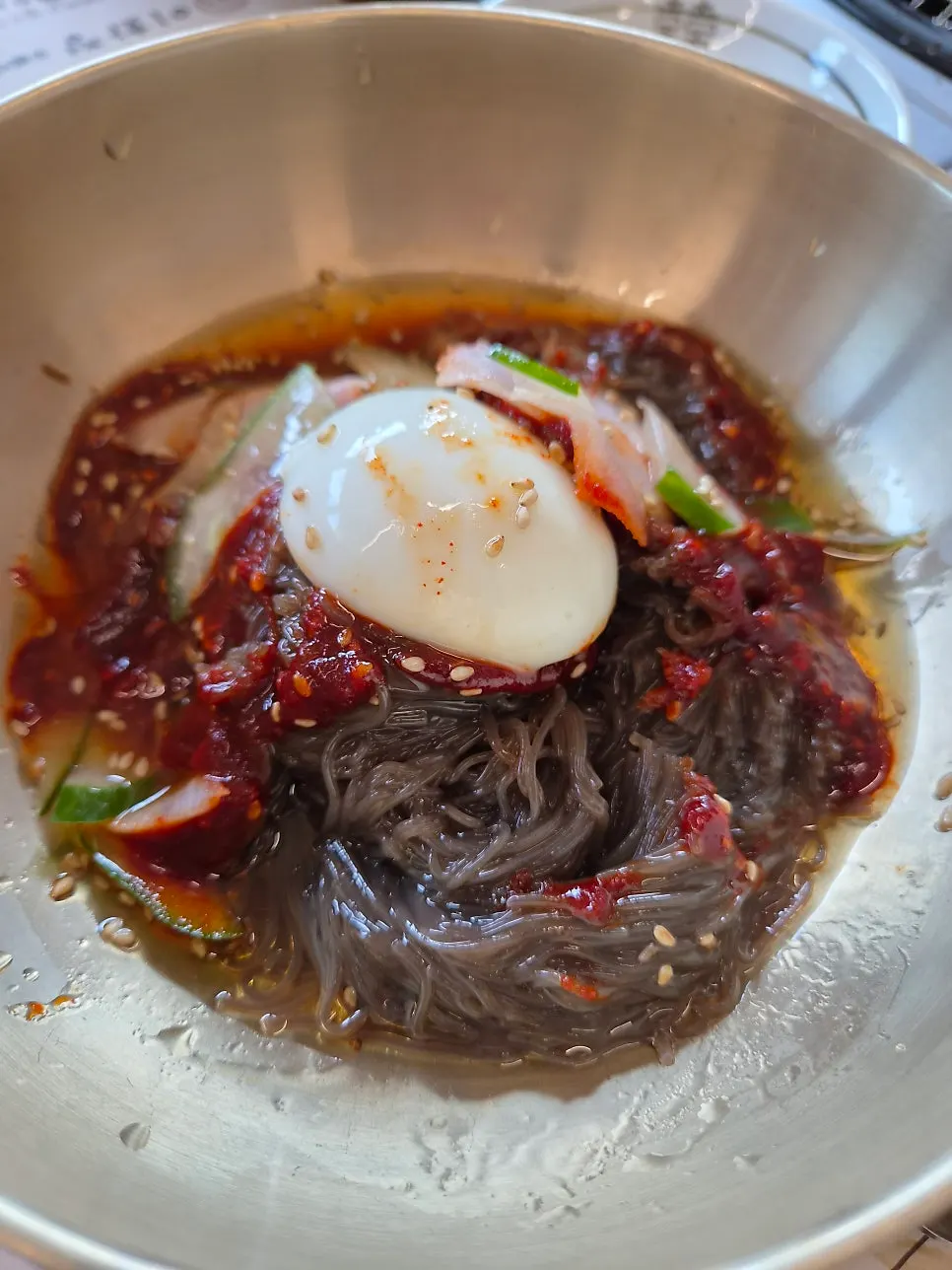 Bibim naengmyeon topped with cucumber and egg