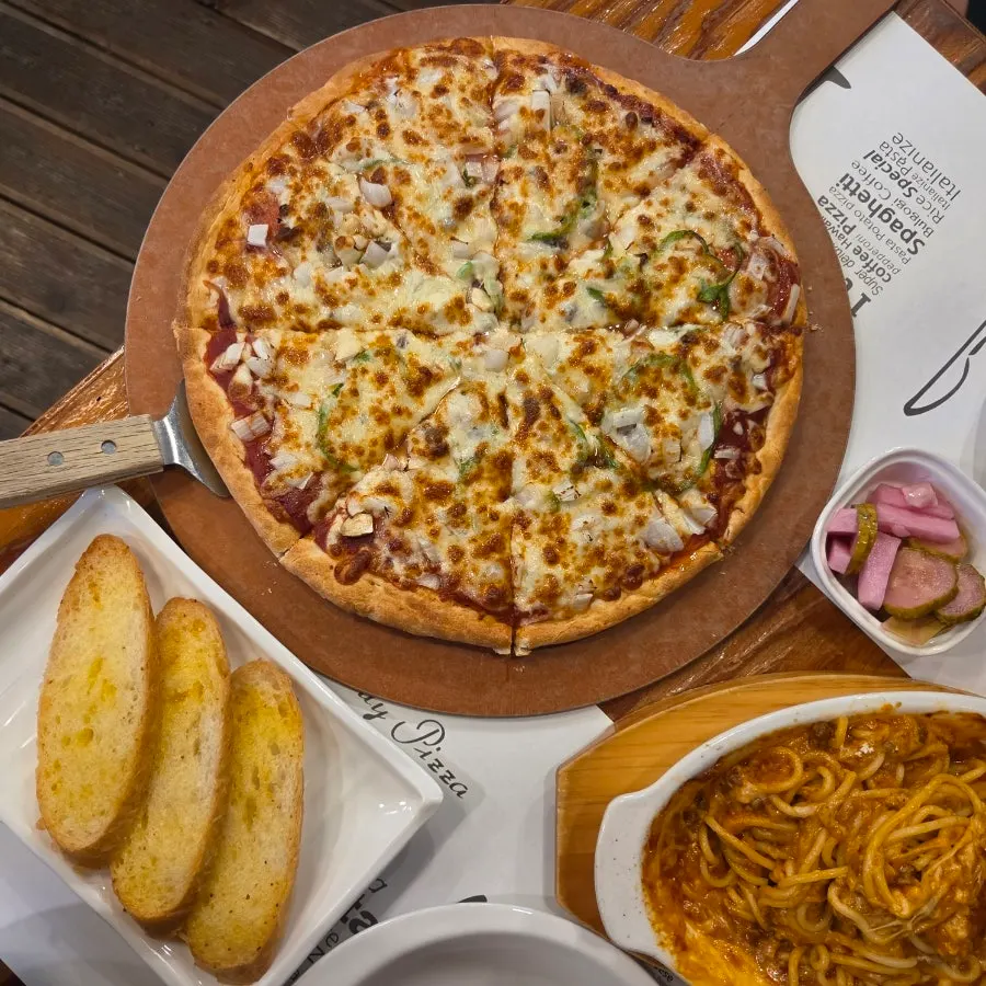 A full spread of combination pizza and oven spaghetti