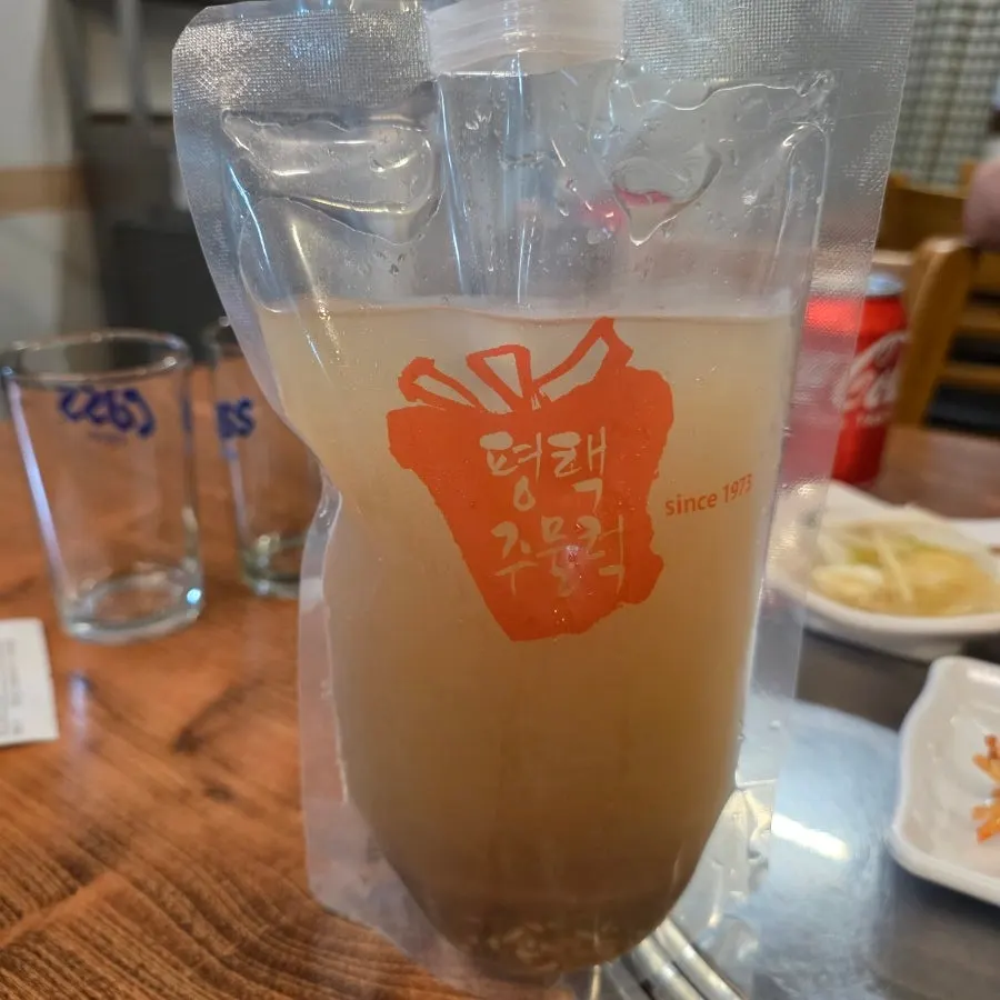 A glass of Pyeongtaek Jumulleok's homemade sikhye