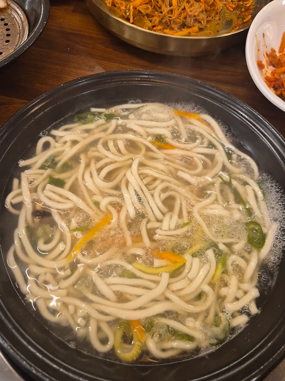 Kalguksu boiling with handmade noodles added