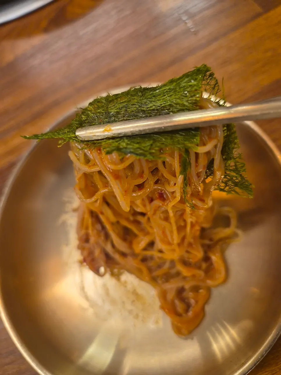 A bite of goldongmyeon wrapped in gamtae seaweed