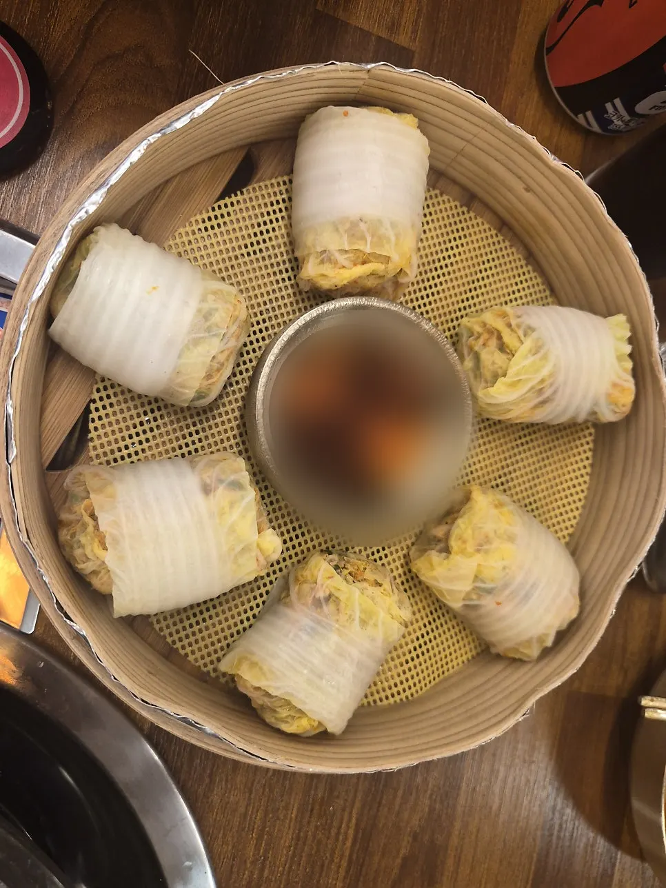 Kimchi dumplings wrapped in napa cabbage leaves