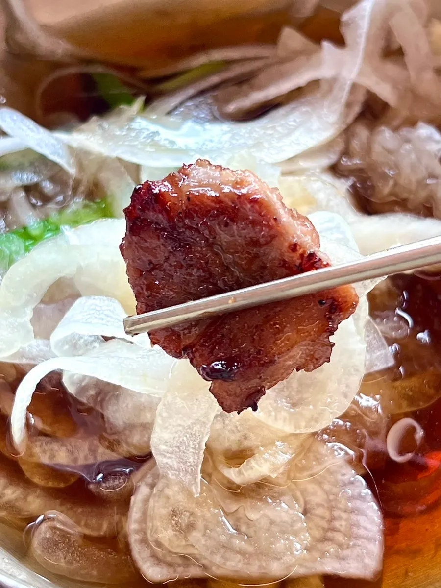 Lettuce wrap topped with mu-saengchae and pickled onions