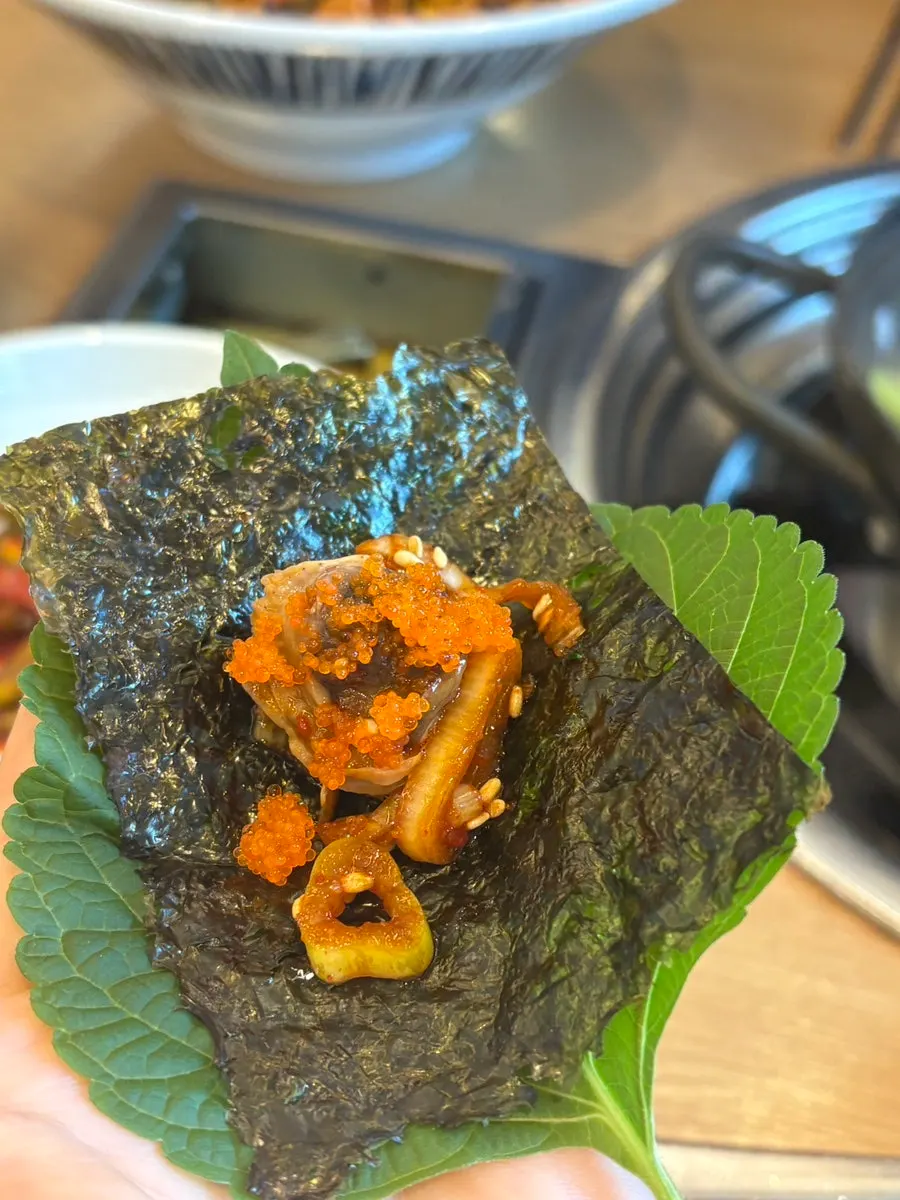 A spoonful of mixed cockle bibimbap