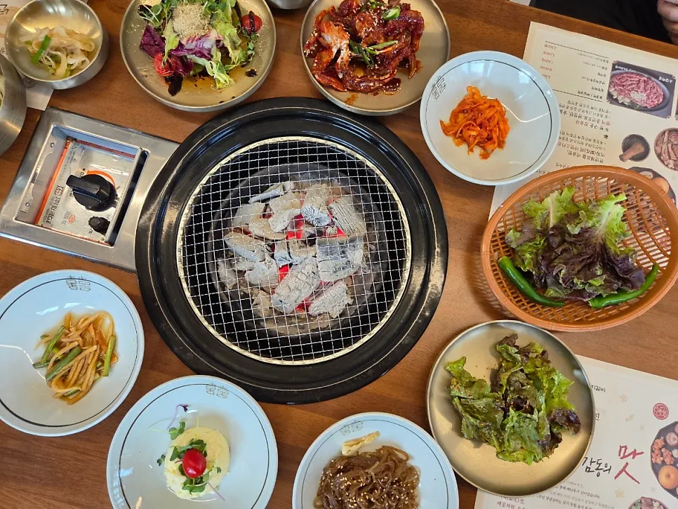 Table set with charcoal grill and banchan