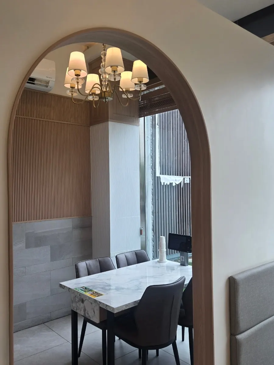 Restaurant seating divided by partitions with floor-to-ceiling windows