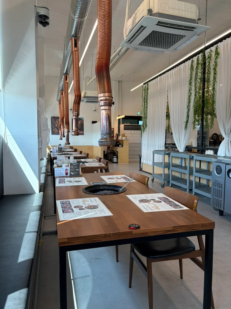 Spacious dining hall with charcoal grill tables