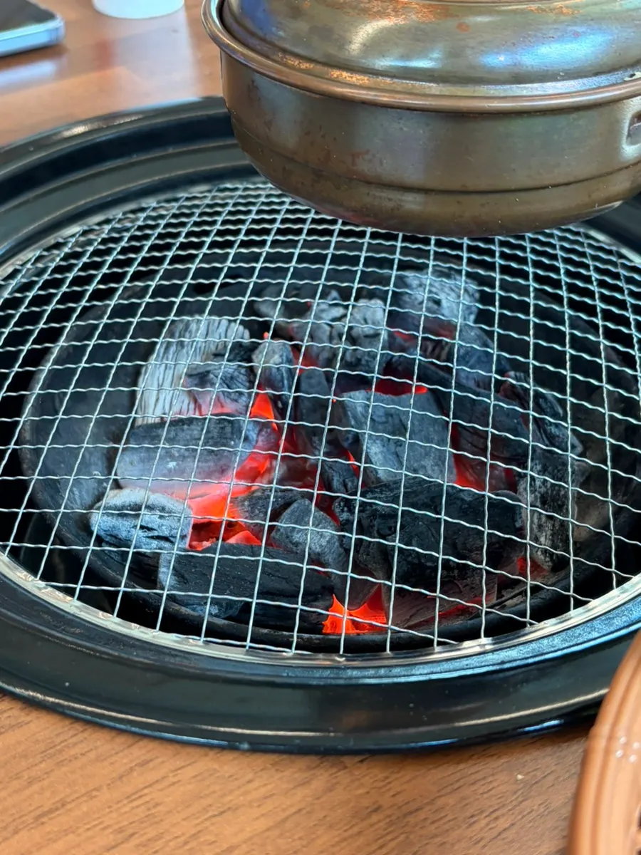Seasoned pork cooking over charcoal
