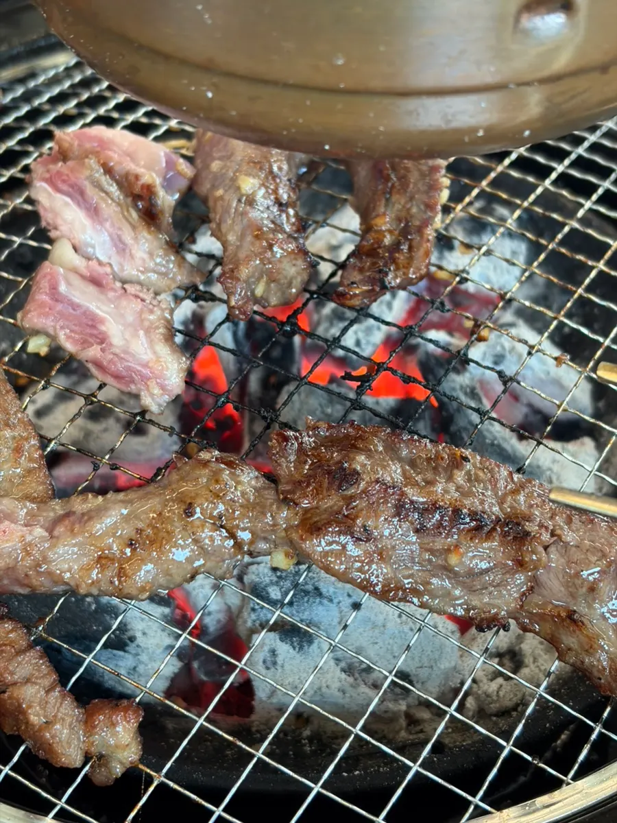 Beef galbisal grilling with garlic over charcoal