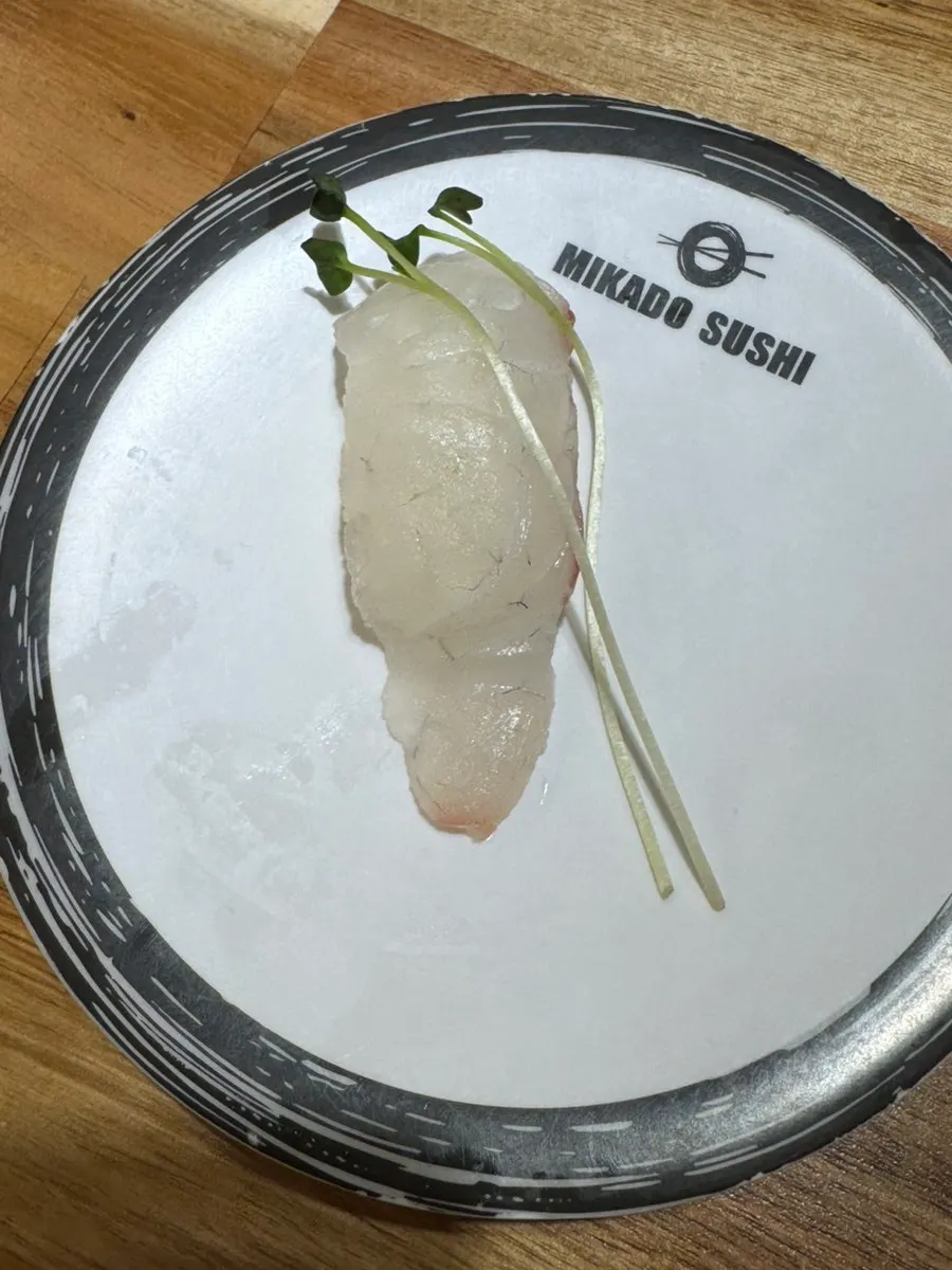 Conveyor-belt sushi plates chosen to suit individual tastes