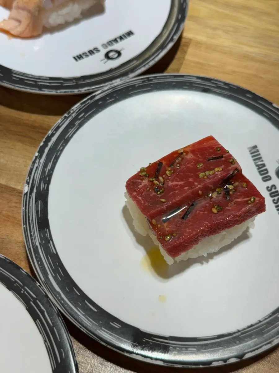 Conveyor-belt sushi plates piling up one by one