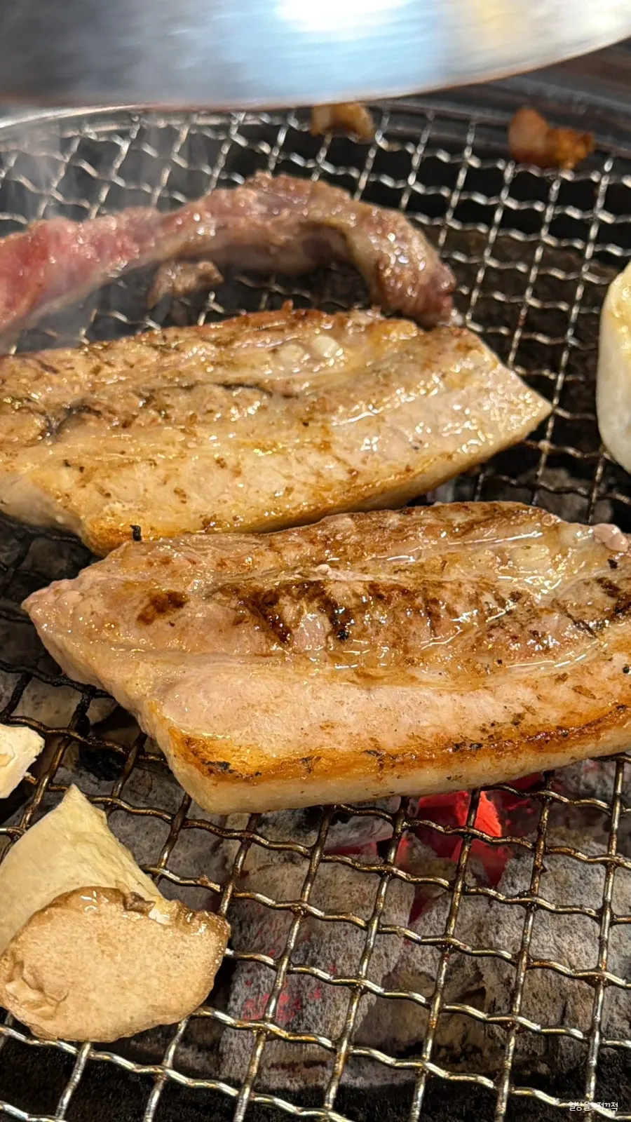 The reordered pork belly back on the charcoal grill