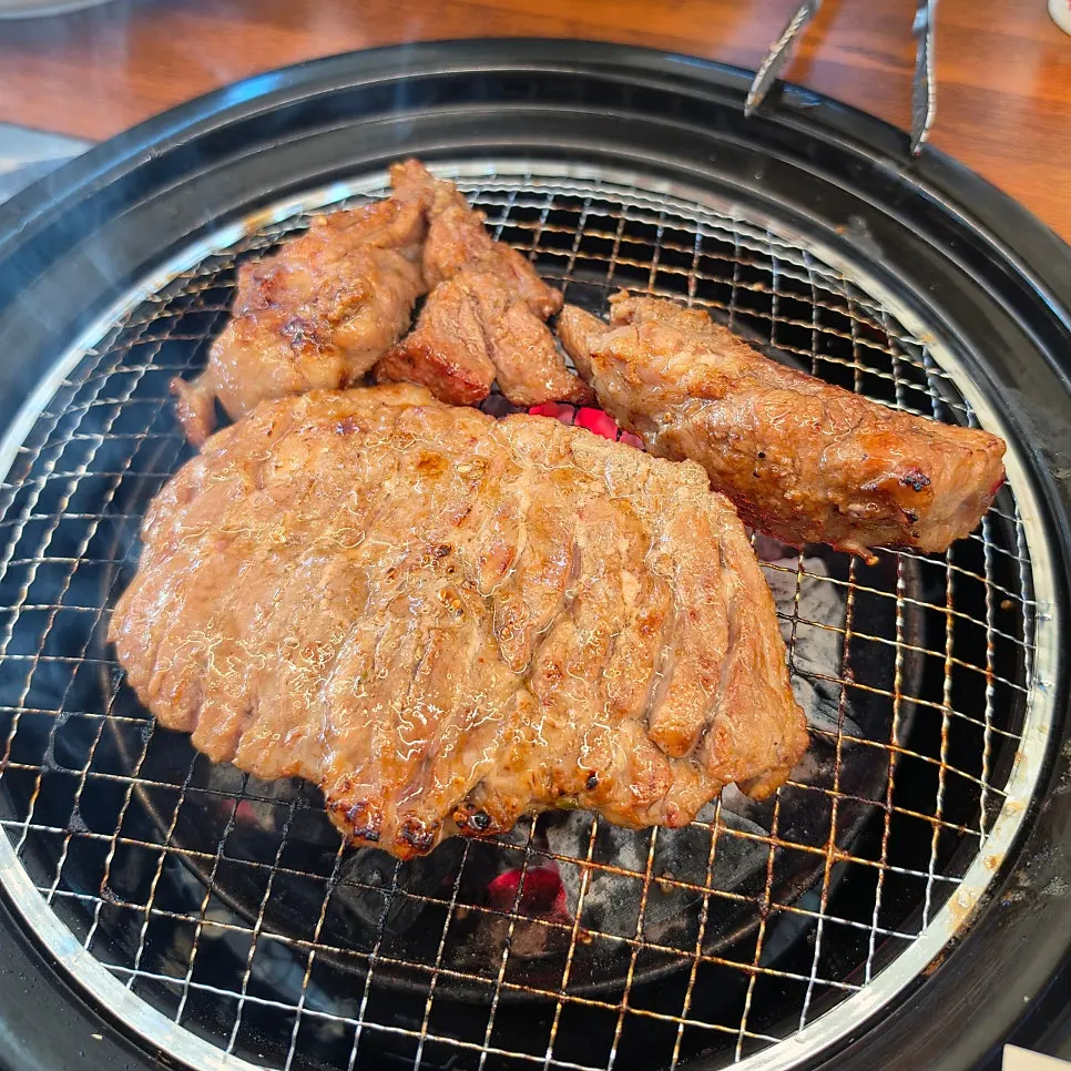 Seasoned galbi turning golden-brown over the charcoal