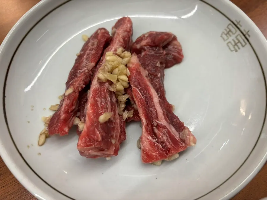Beef galbisal served with minced garlic on top