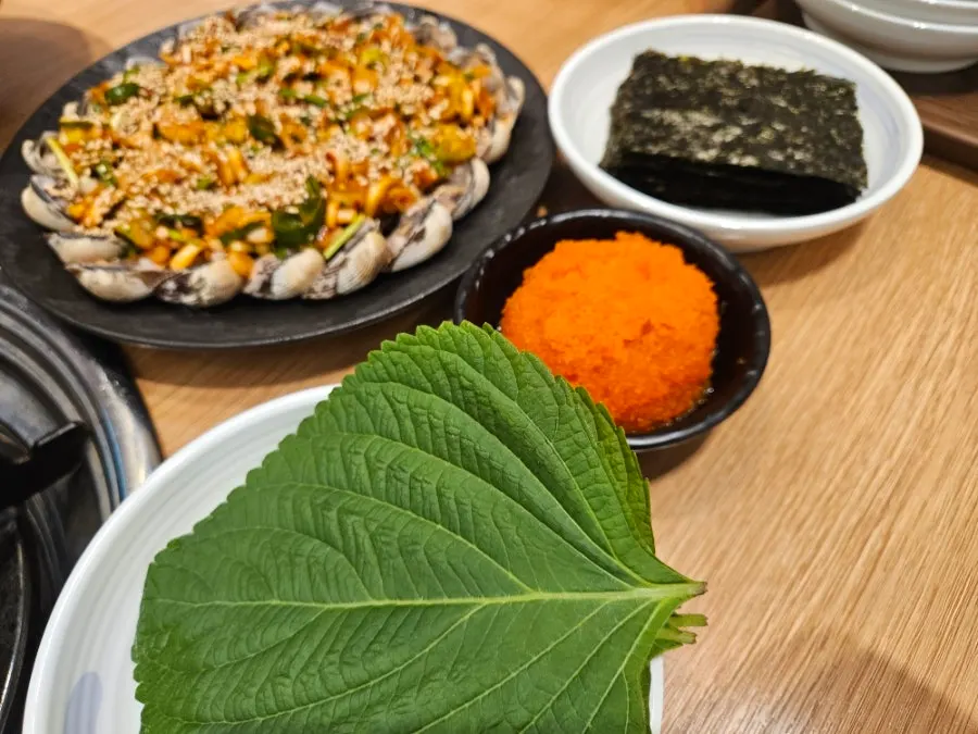 Plate of Manse Seasoned Cockles topped with flying fish roe and sesame seeds