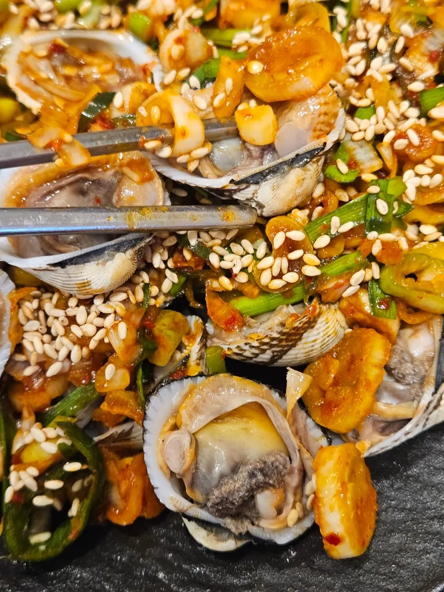 Top view of Manse Seasoned Cockles heaped with flying fish roe