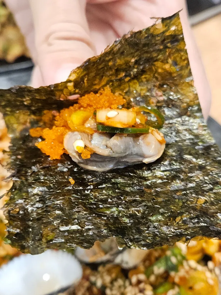 Seasoned cockles wrapped in perilla leaf and laver