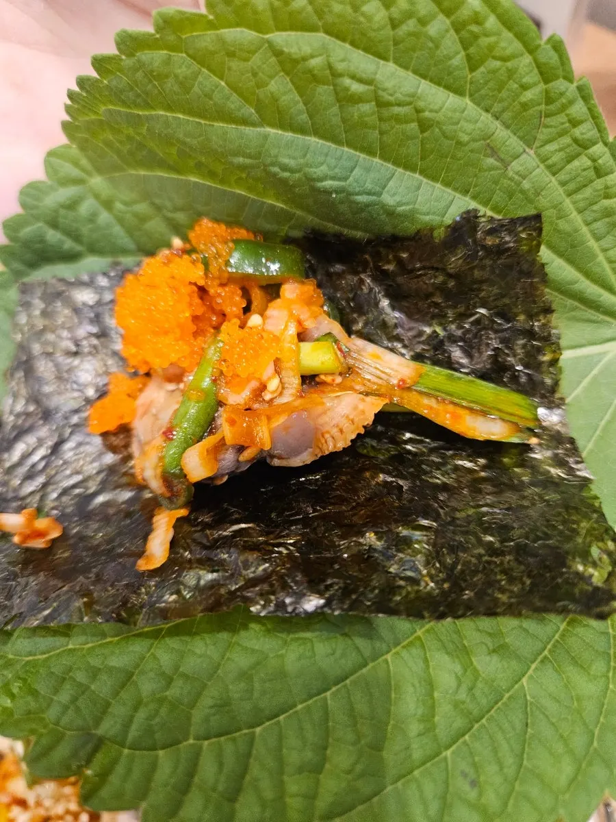 A bite-sized seasoned cockle wrap