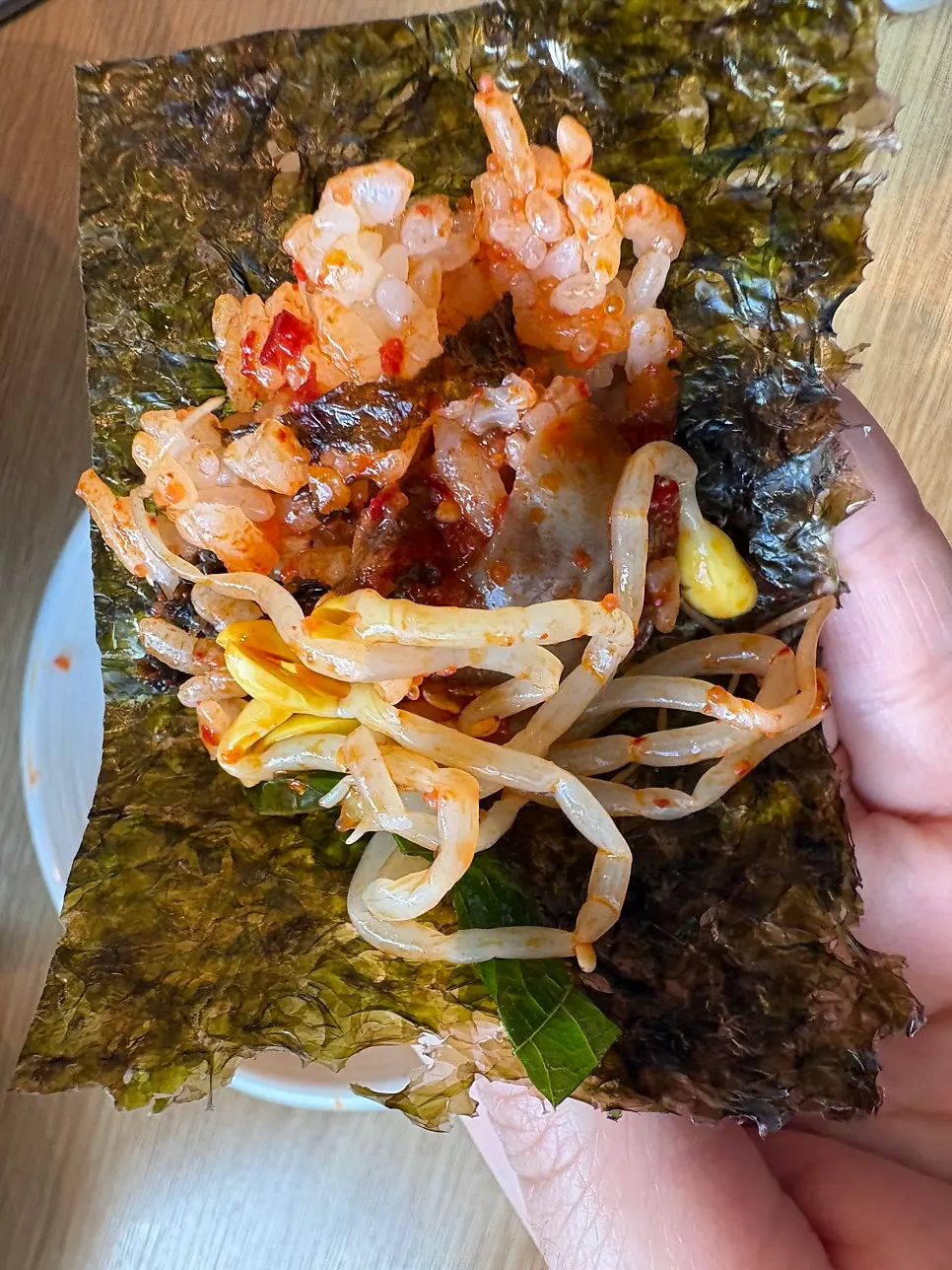 Red cockle bibimbap topped with perilla leaf and flying fish roe