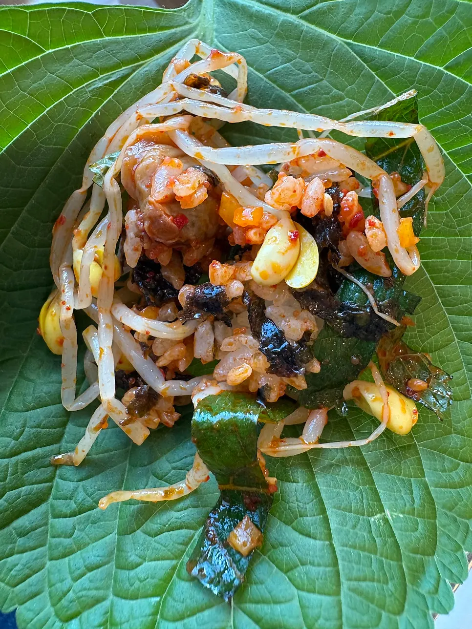 A spoonful of the mixed red cockle bibimbap