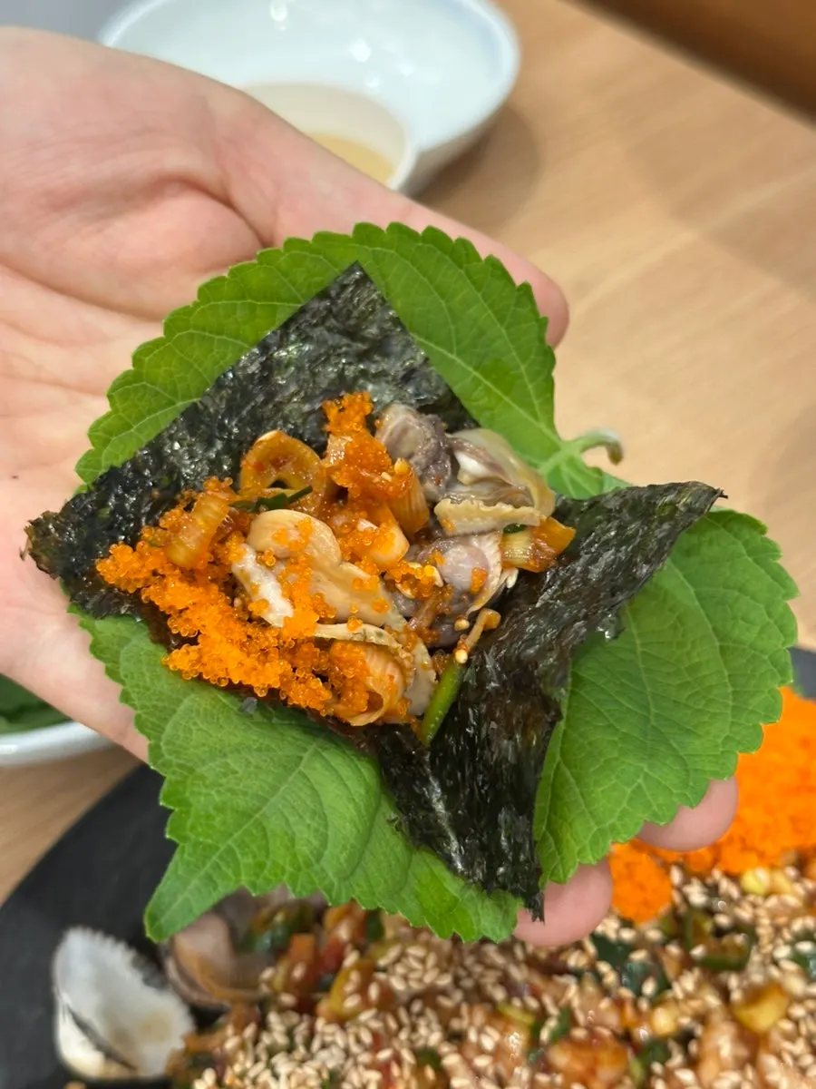 A spoonful of seasoned cockles scooped up