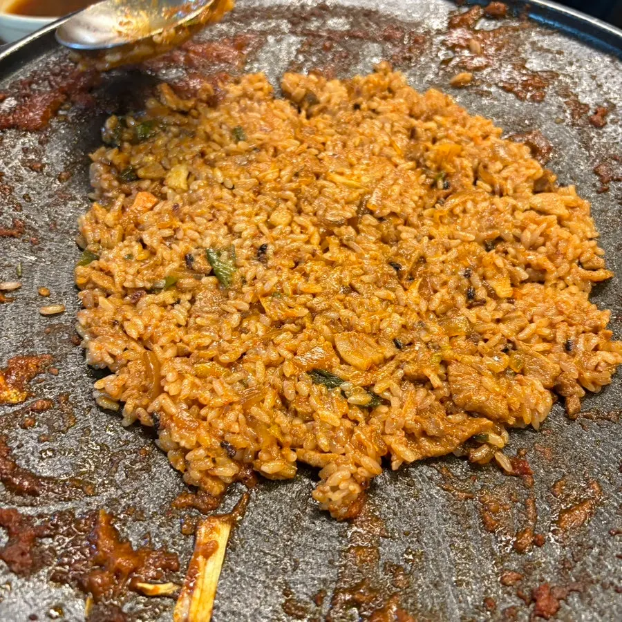 Gochujang jumulleok fried rice being cooked on the griddle