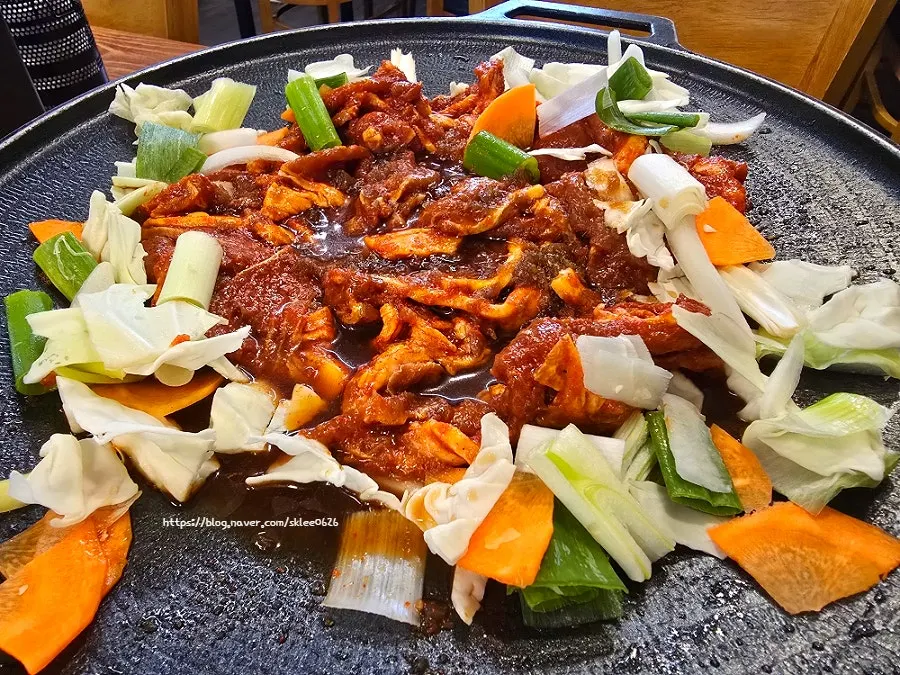 Two servings of gochujang jumulleok on the grill
