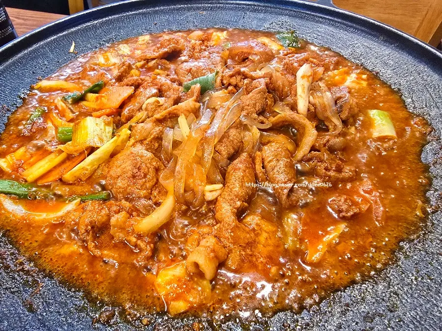Gochujang jumulleok simmering with flat glass noodles