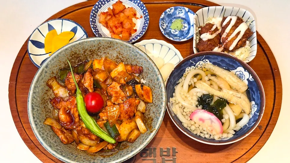Two set meals served on a wooden tray
