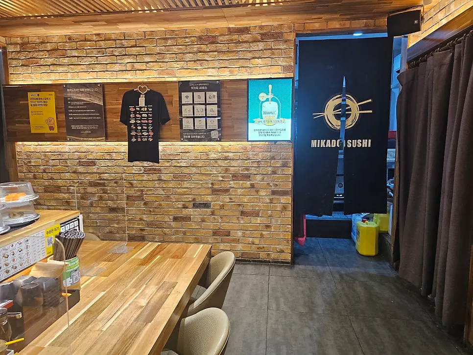 Interior of the conveyor-belt sushi restaurant with wood-tone and brick decor