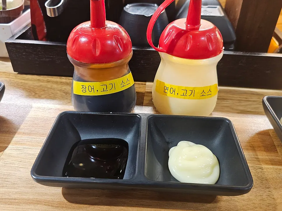 Various sauces served alongside the sushi