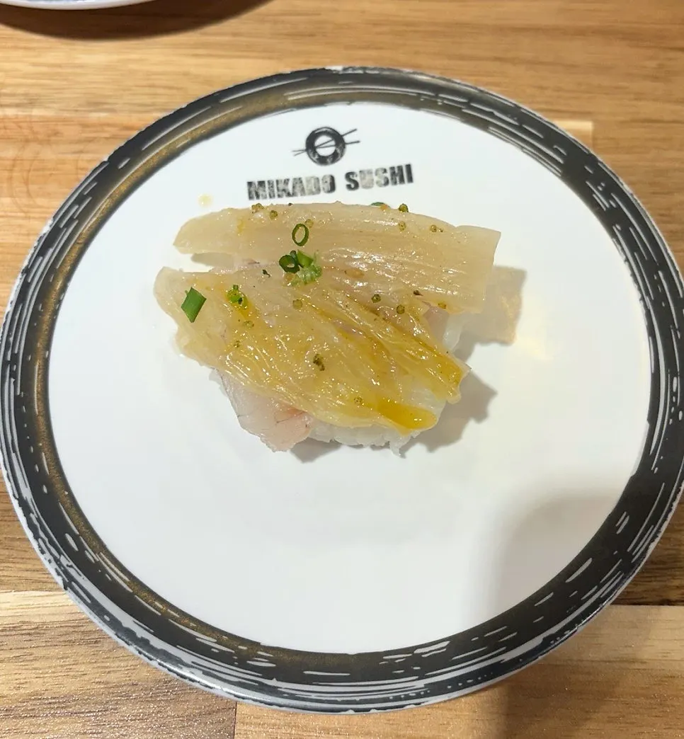 Live fish sushi topped with aged kimchi