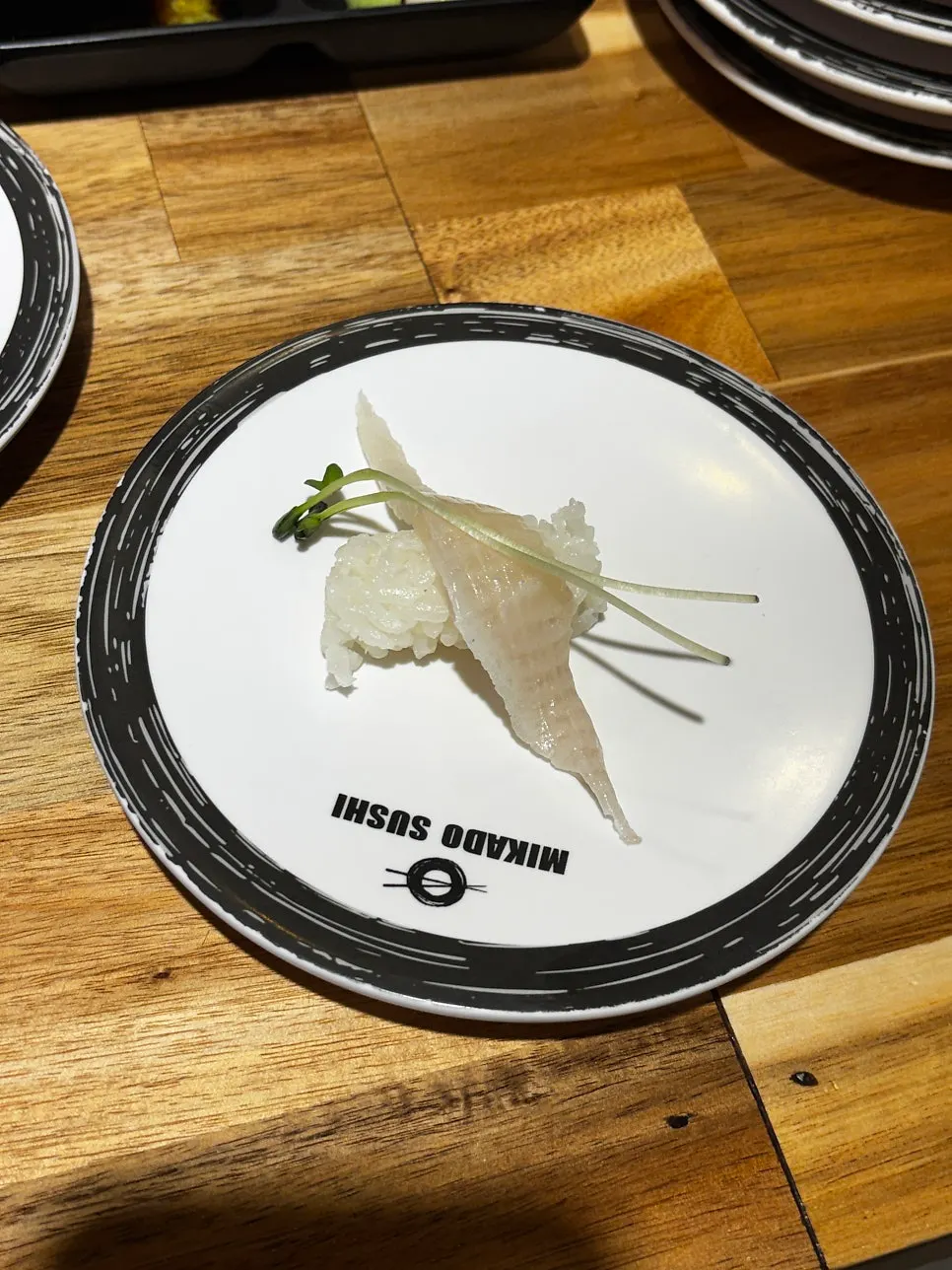 A table stacked with multiple sushi plates