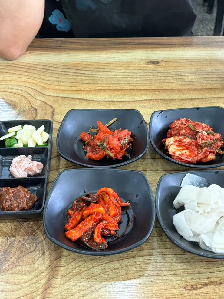Basic side dishes including raw fish salad and fresh kimchi