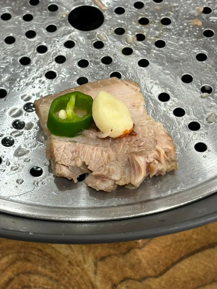 A tender piece of boiled pork belly bossam