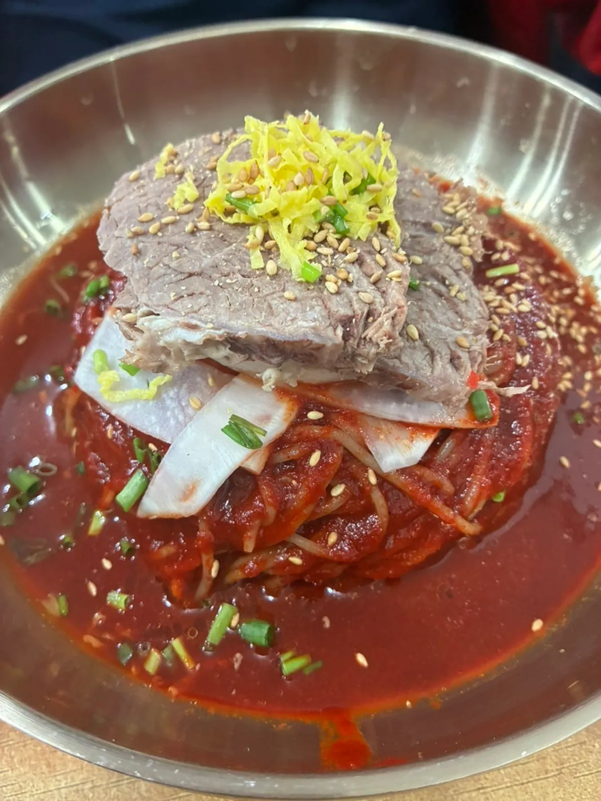Large bibim naengmyeon covered in spicy sauce
