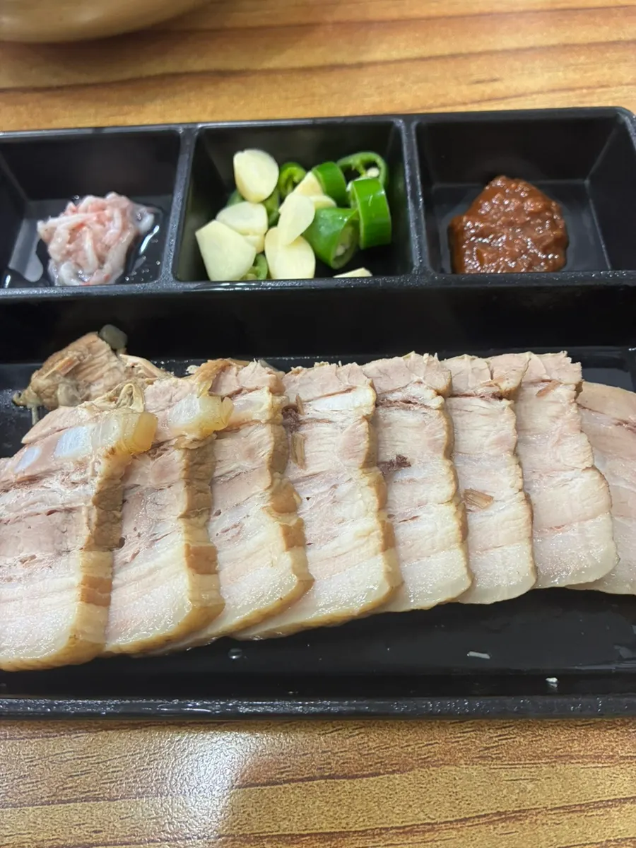 Pork belly suyuk served with soybean paste, garlic, and salted shrimp