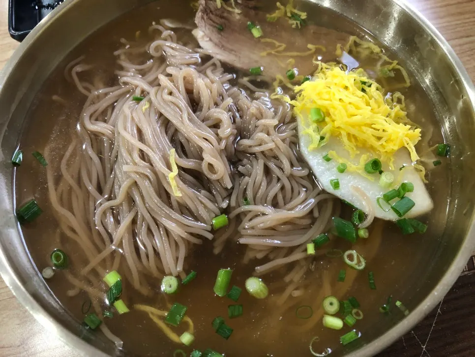 Noodles lifted from a bowl of Seoul Myeonok's pyongyang naengmyeon