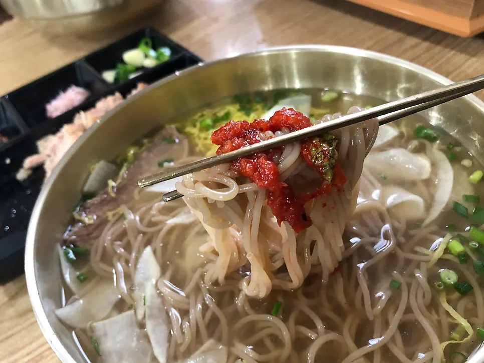 Bowl of pyongyang naengmyeon with wasabi stirred in