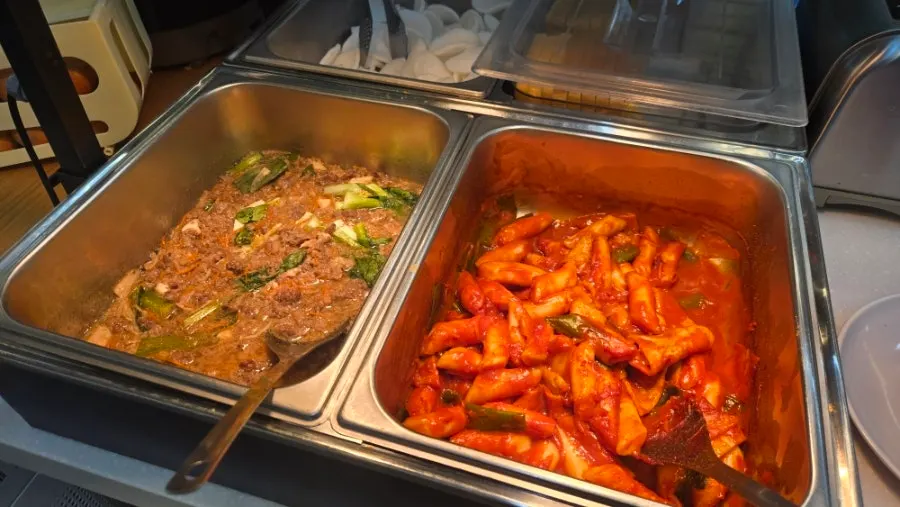 Self-serve side dishes including tteokbokki and bulgogi