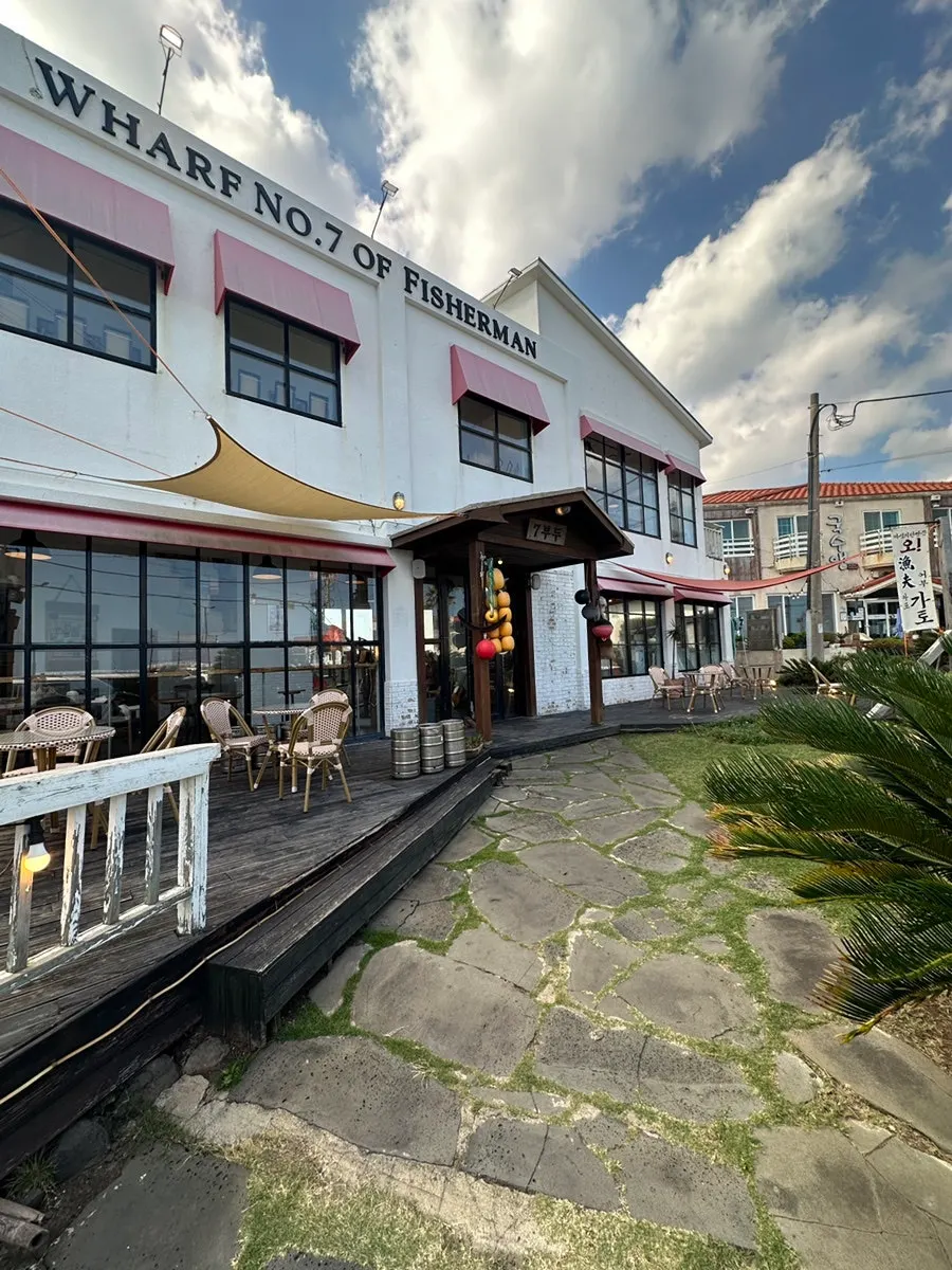 The wide grass yard in front of the café